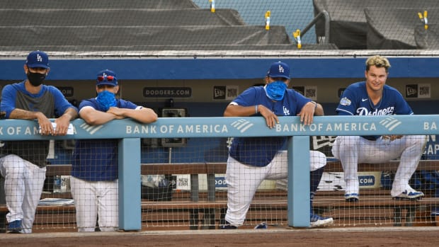 Jul 6, 2020; Los Angeles, California, United States; Los Angeles Dodgers right fielder Joc Pederson (far right) watches the action from the dugout during an intrasquad game at Dodger Stadium. Mandatory Credit: Robert Hanashiro-USA TODAY Sports